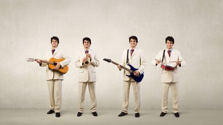 Man orchestra in suit playing different music instrumentsの写真素材