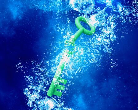 Key sinking and dissolving in clear blue waterの写真素材