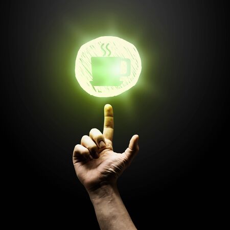 Person hand pointing with finger at glowing icon