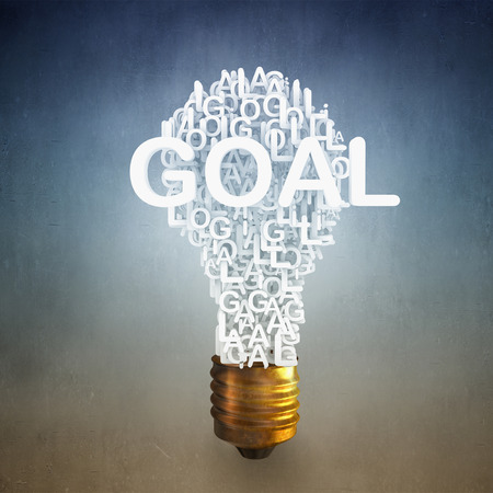 Light bulb with goal word on concrete backgroundの写真素材