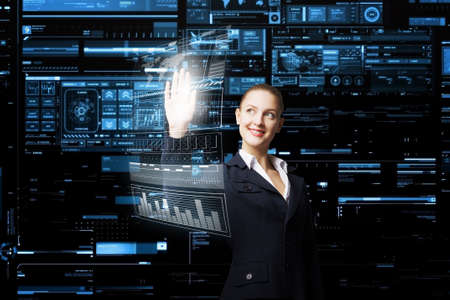 Attractive elegant businesswoman working with virtual panel interface