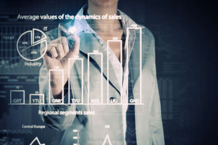 Chest view of businesswoman drawing infographs on digital screenの写真素材