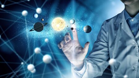 Woman scientist touching with finger virtual media screenの写真素材