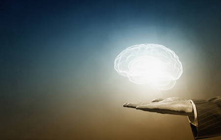 Male hands holding image of human brainの写真素材