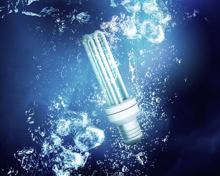 Energy concept with light bulb under clear blue water