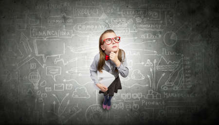 Wideangle picture of funny schoolgirl with paper plane in handの写真素材