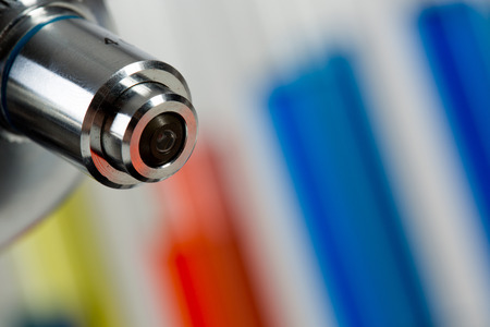 Glass tubes with color liquids and microscope in science laboratoryの写真素材