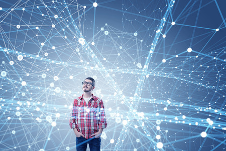 Young man in checked shirt and glasses among connection lines
