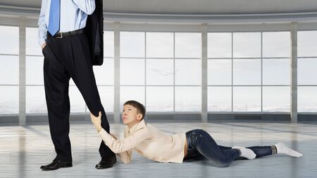 Close up of legs of man going to work and his wife asking him not to goの写真素材