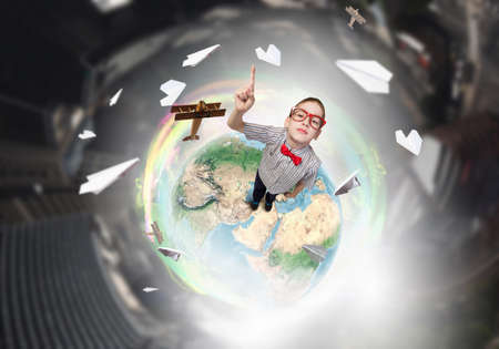 Top view of cute schoolboy in red glasses with finger up. Elements of this image are furnished by NASAの写真素材