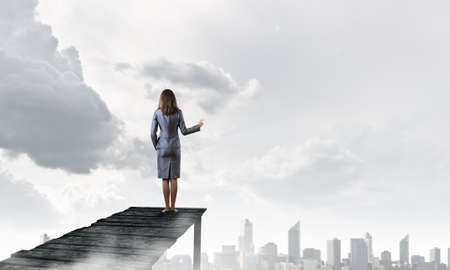Businesswoman standing on dock and enjoying the viewの写真素材