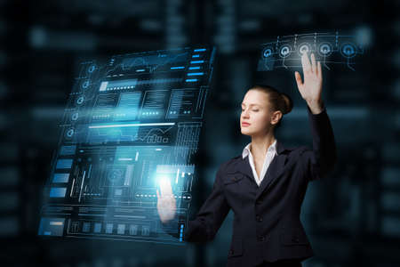 Attractive elegant businesswoman working with virtual panel interface