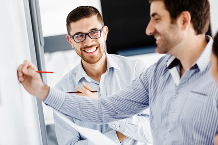 Business people working and discussing in modern officeの写真素材