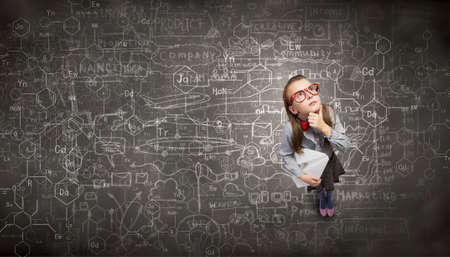 Wideangle picture of funny schoolgirl with paper plane in handの写真素材