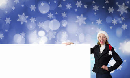 Woman in Santa hat with blank banner. Place for your textの写真素材