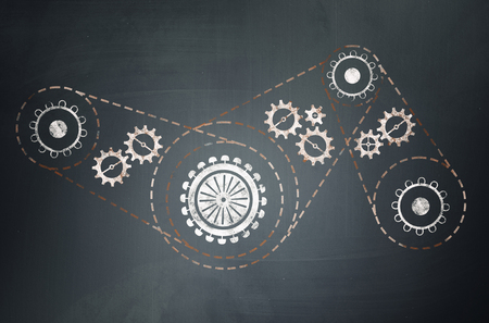 Chalk drawn gears and cogwheels mechanism as teamwork conceptの写真素材
