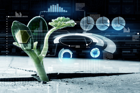 Green growing from crack sprout and digital interfaceの写真素材