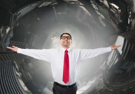 Confident businessman with hands spread apart on cityscape background