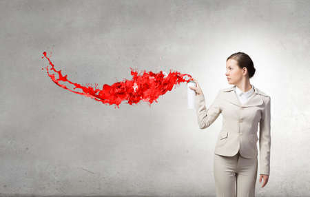 Young elegant businesswoman with white spray balloon in hand