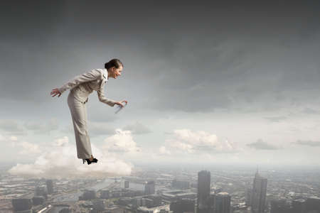 Young elegant businesswoman with white spray balloon in hand