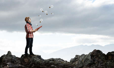 Hipster guy in checked shirt with book in handsの写真素材