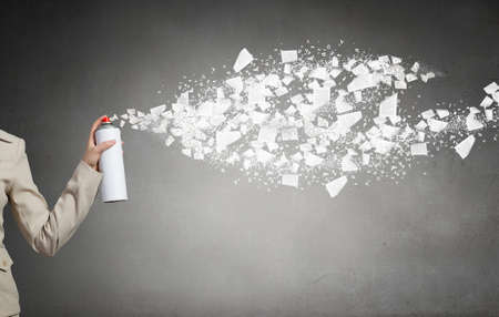 Young elegant businesswoman with white spray balloon in handの写真素材