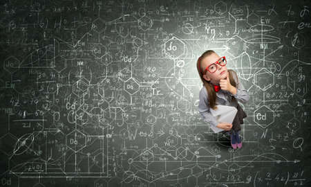 Wideangle picture of funny schoolgirl with paper plane in handの写真素材