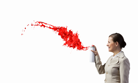Young elegant businesswoman with white spray balloon in handの写真素材