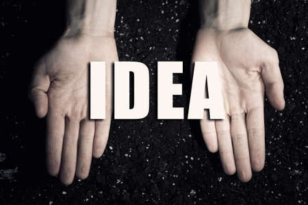 Male hands on soil background showing in palms business conceptual word