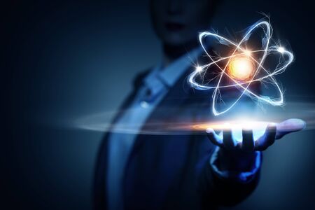 Woman scientist presenting atom research conceptの写真素材