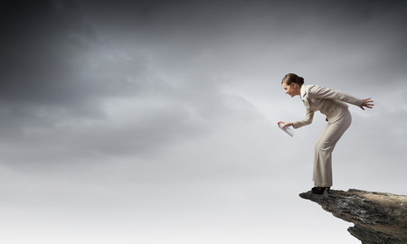 Young elegant businesswoman with white spray balloon in handの写真素材