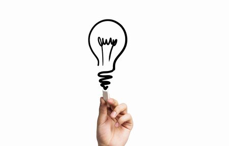 Hand drawing with chalk light bulb as idea symbol on blackboardの写真素材