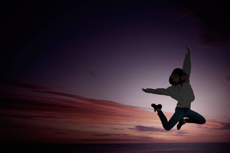 Silhouette of young girl in jump presenting freedom and happiness concept