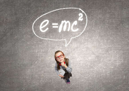 Wideangle picture of funny schoolgirl with paper plane in handの写真素材