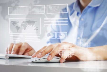 Close up of businessman using computer at desk in office