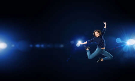 Silhouette of young girl in jump presenting freedom and happiness conceptの写真素材
