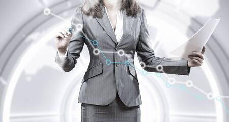 Close view of businesswoman drawing on screen market infographsの写真素材