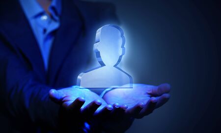 Close up of businesswoman hand holding digital icon in palmの写真素材