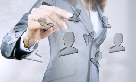 Businesswoman pressing modern social icon with stylus on screenの写真素材