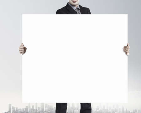 Businessman show white blank banner with place for textの写真素材