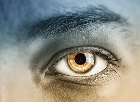 Close up of human eye on digital technology backgroundの写真素材
