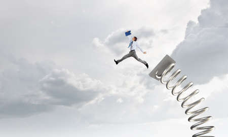 Businessman jumping on springboard as progress concept