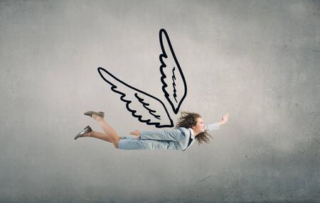 Young businesswoman in suit flying high in sky