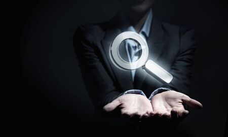 Close up of businesswoman hand holding digital icon in palmの写真素材