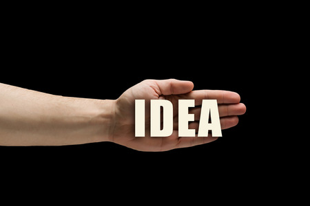 Male hands on dark background showing in palms conceptual wordの写真素材