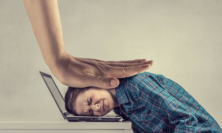 Woman programmer pressed with hand to laptop