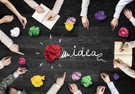 Top view of business people working together while sitting at table