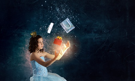 Little girl princess in blue dress with diadem on head