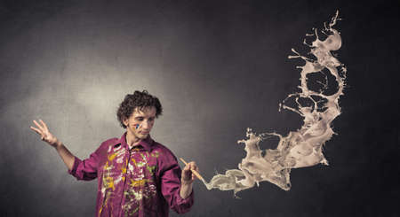 Young handsome man painter with brush in hand