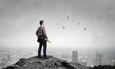 Builder man in checked shirt with tool belt on waistの写真素材